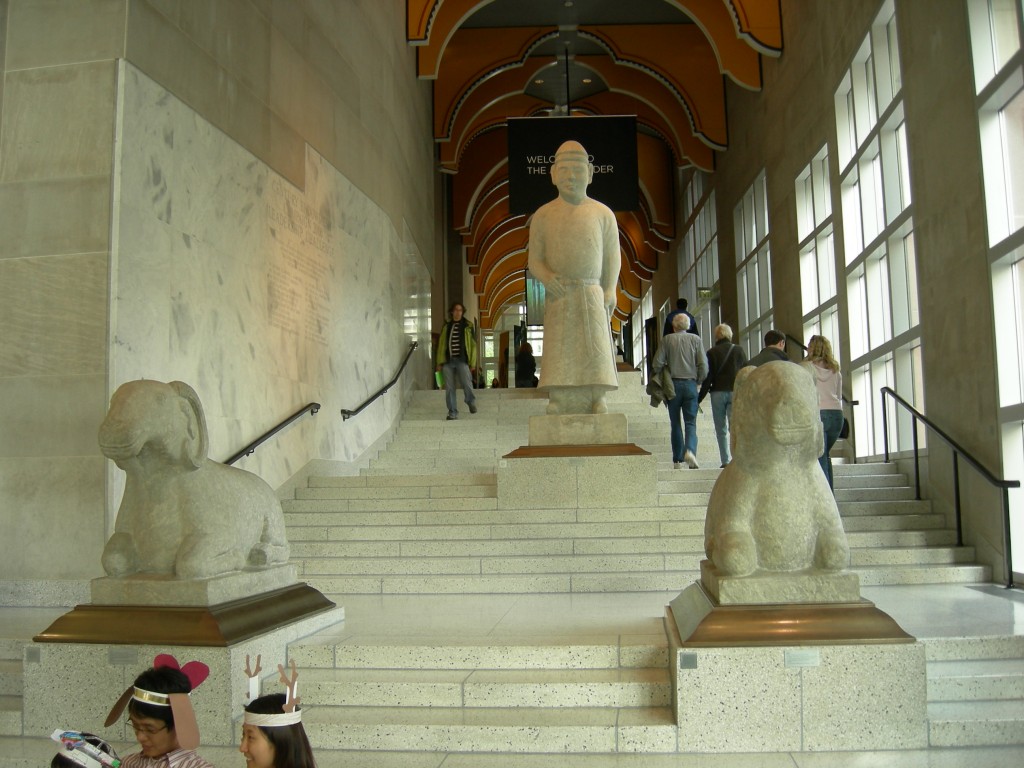 The "Art Ladder," the main staircase of the original Robert Venturi portion of the Seattle Art Museum. The visible statues are Chinese funerary statues: two rams and a civilian guardian. May 5, 2007. Photo by Joe Mabel/Wikimedia Commons