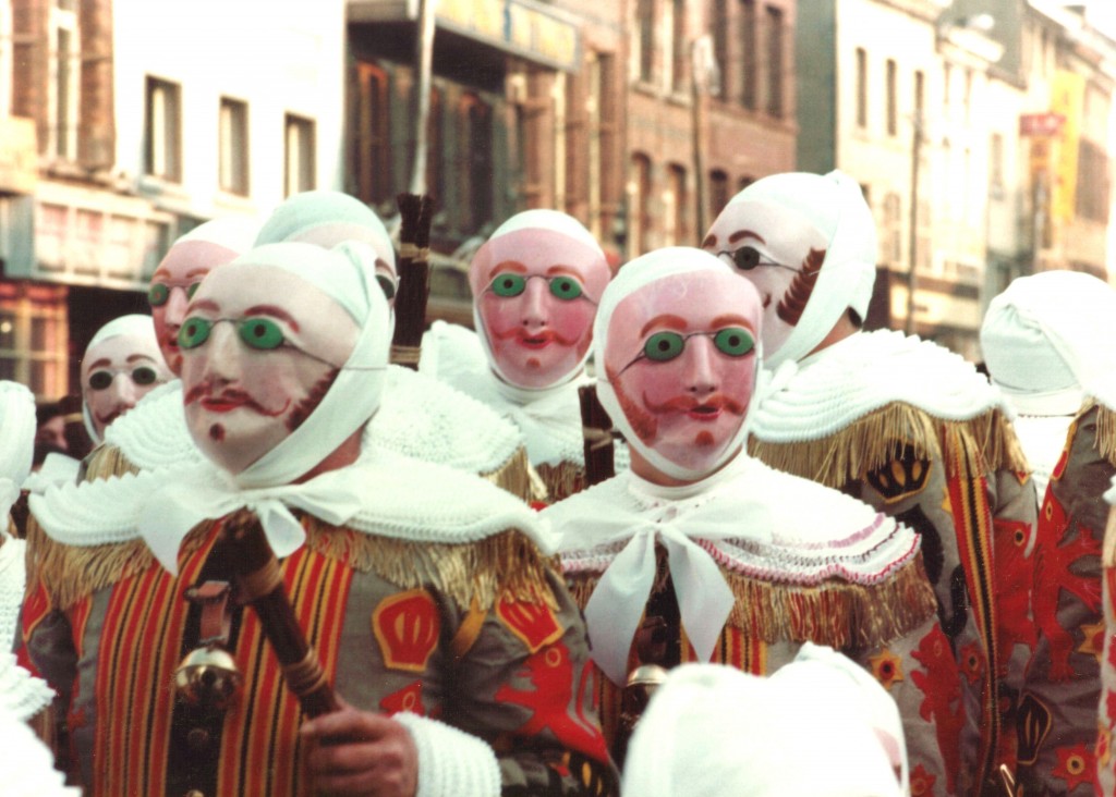 In Binche, Belgium, Les Gilles, an all-male group of about 1,000 Mardi Gras revelers, wearing their masks; 1982. Photo: Marie-Claire/Wikimedia Commons.
