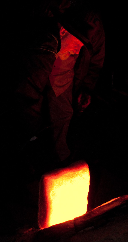 Nils Lou, longtime keeper of the East Creek kiln, checks the fire. Photo: RICHARD YATES